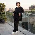 Fließendes Shirt aus schwarzem Jersey mit femininer Silhouette und leicht zipfeligem Saum
