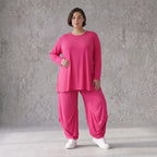 Pinkes Langarmshirt in Glockenform aus softer Slinkyqualität mit Rundhalsausschnitt