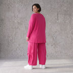 Pinkes Langarmshirt in Glockenform aus softer Slinkyqualität mit Rundhalsausschnitt