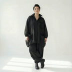 Schwarze Oversizejacke mit Raffdetails langer Schnitt Knopfleiste Taschen Polyester