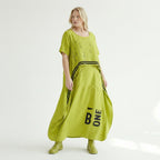 Oversize Maxikleid in neongrün schwarz mit Frontprint Rundhals Taschen Baumwolljersey