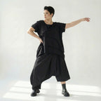Asymmetrische schwarze Ballonhose aus Baumwolle mit Stretch oversized Eingrifftaschen